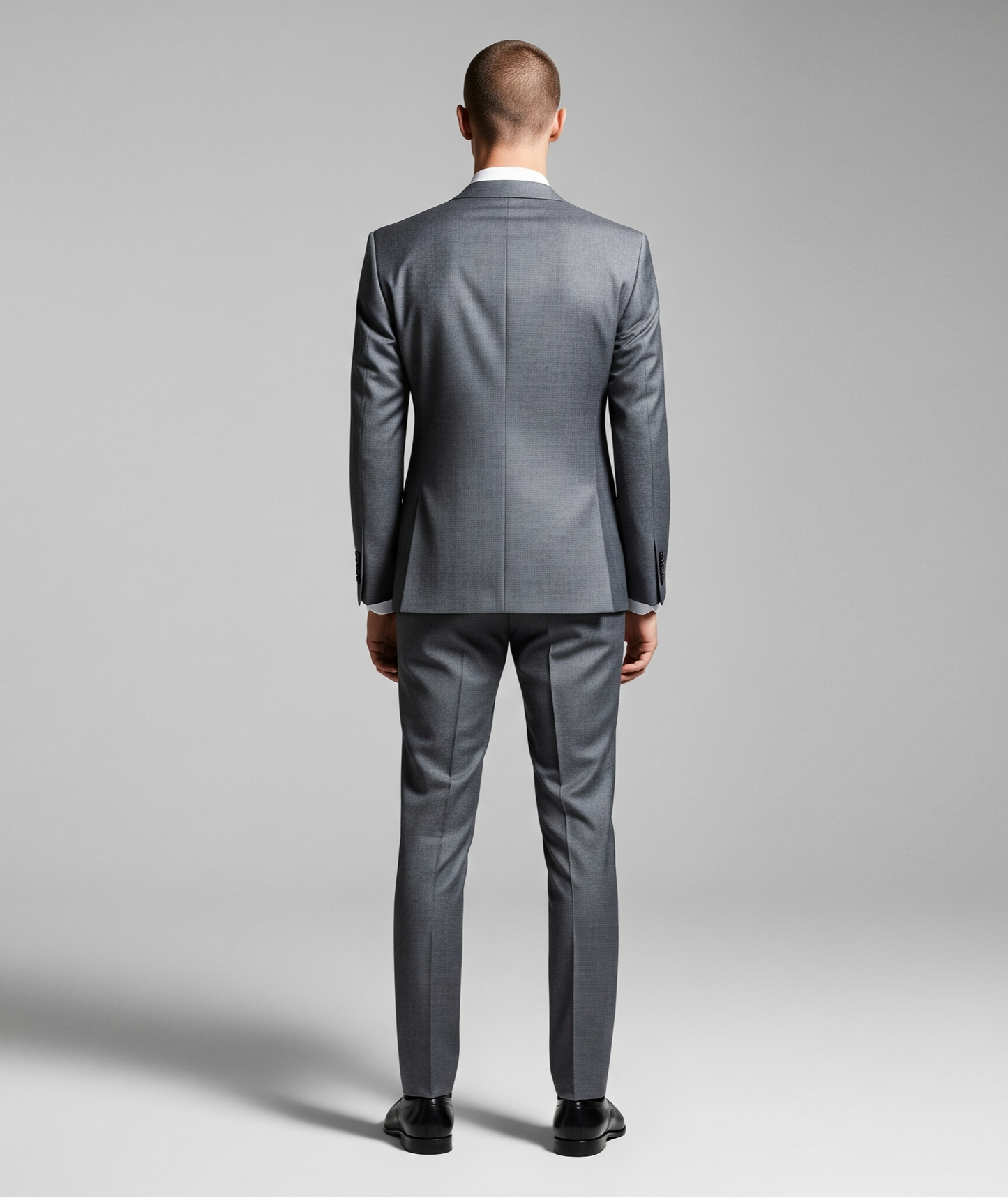 Man wearing a gray suit on a plain background